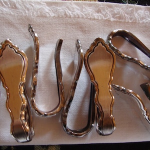 Acht Serviettenhalter aus Silber