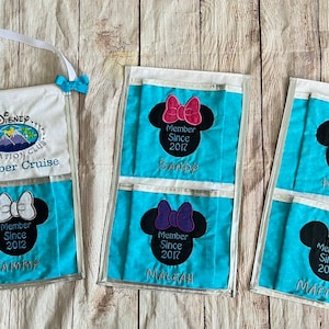 May include: A set of three blue and white fabric organizers with clear plastic pockets. Each organizer features a black and white embroidered Mickey Mouse head with a bow and text that reads "Member Since" followed by a year. The names "Tanner", "Maliah", "Kylie", and "Matthew" are embroidered below the Mickey Mouse heads.