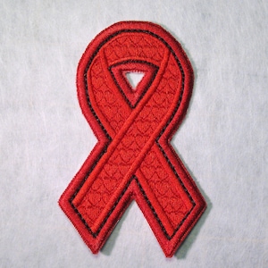 May include: A red ribbon with a black outline, sewn with a textured pattern. The ribbon is in the shape of a traditional awareness ribbon.