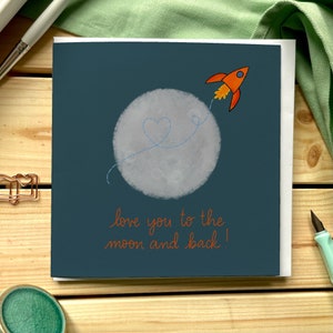 Biglietto di auguri - Ti amo fino alla luna e ritorno con razzo e scia a forma di cuore