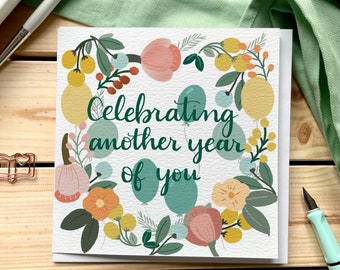 Celebrating another year of you birthday card with modern calligraphy and flowers and balloons in teal blue and mustard yellow