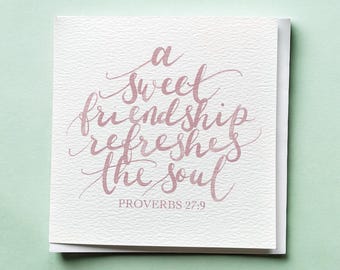 May include: A square greeting card with the quote "a sweet friendship refreshes the soul" in pink calligraphy. The text "PROVERBS 27:9" is below the quote. The card is on a light green background.