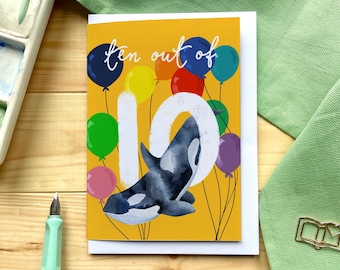 Tenth birthday card “ten out of 10” with orca whales, balloons and big number ten