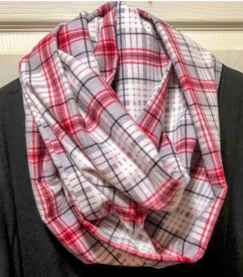 May include: A red and white plaid infinity scarf. The scarf is made of a soft, comfortable fabric and is perfect for keeping warm in the winter.