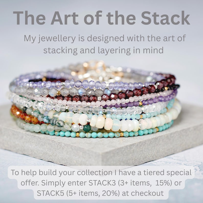 Puede incluir: Una pila de pulseras de cuentas de piedras preciosas multicolores con cuentas redondas facetadas y lisas en tonos turquesa, blanco, naranja, morado y gris. El texto dice: The Art of the Stack, My jewellery is designed with the art of stacking and layering in mind, To help build your collection I have a tiered special offer. Simply enter STACK3 (3+ items, 15%) or STACK5 (5+ items, 20%) at checkout.