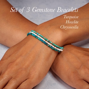 May include: Set of 3 gemstone bracelets featuring turquoise, howlite, and chrysocolla beads. The bracelets are layered on a wrist, showcasing the different colors and textures of the gemstones. The text "Set of 3 Gemstone Bracelets" is visible.