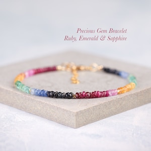 May include: A delicate bracelet made with tiny gemstones in shades of red, green, blue, and yellow. The bracelet is made with ruby, emerald, and sapphire gemstones.  Precious Gem Bracelet Ruby, Emerald & Sapphire