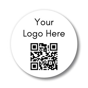 May include: A white, circular sticker with the text "Your Logo Here" in black, along with a black QR code. The sticker has a subtle shadow, suggesting a raised surface. Ideal for branding and product labeling.