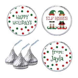 May include: Hershey's Kisses with festive holiday-themed labels. The labels feature red and green polka dots and text that reads "Happy Holidays", "Elf Kisses", and "from: Jayla".