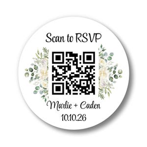 May include: A white, round sticker with a QR code in the center, surrounded by floral accents. The text "Scan to RSVP" is above the QR code, with "Marlie + Caden" and the date "10.10.26" below. The design features soft, watercolor-style flowers.
