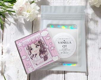 May include: A pink square item with the name "DANNI" in a comic book style, featuring an anime-style character. Beside it is a white pouch with a label that reads "VANILLA QT" and "Signature Scent Putty".
