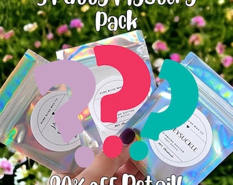 May include: Three silver holographic pouches with a question mark design. Each pouch contains a mystery putty scent. The pouches are labeled with the text "Pure Bliss Wax Co." and "Eysuckle". The text "20% off Retail!" is at the bottom of the image.