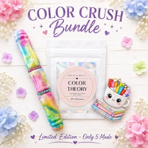 May include: A Color Crush Bundle featuring a multi-colored swirled resin stylus with two rhinestone bands, a white pouch labeled Color Theory Diamond Dotter's Dot Putty by Pure Bliss Wax Co, and a sticker of a mug filled with colored pencils.