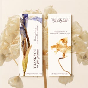 May include: Two rectangular thank you cards with white backgrounds. The left card features a blue and brown iris illustration with the text "THANK YOU for your purchase" and "I hope you love it as much as I love making it." The right card shows a brown flower with the same text and "info@yourwebsite.com."