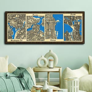 May include: A wooden wall art piece featuring four detailed maps of major US cities: Washington DC, Boston, Chicago, and Seattle. Each map is framed in a dark brown wood frame and features a blue water body.