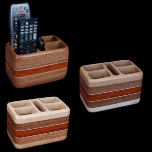 Hardwood remote control holder holds four remotes and smartphone.