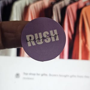May include: Purple round sticker with the text "Rush shipping" in white lettering.