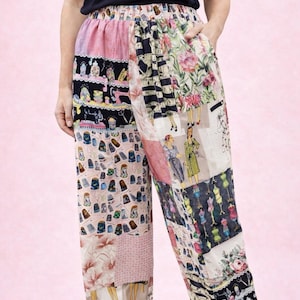 May include: High-waisted trousers featuring a patchwork design with various sewing-themed illustrations, including vintage sewing machines, thimbles, dress forms, and figures in retro clothing, rendered in a palette of pink, black, and white.