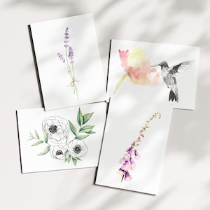 Watercolor greeting card set with 4 botanical designs: purple lavender bundle, hummingbird with colorful flowers, black and white peonies with green leaves, and purple foxglove stem. Hand-painted floral cards perfect for any occasion. Blank inside for personal messages.