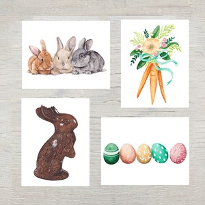 May include: A set of four watercolor illustrations featuring three rabbits sitting together, a bouquet of orange carrots tied with a teal ribbon, a brown chocolate bunny with a bitten ear, and five decorative Easter eggs in green, pink, and yellow.