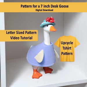 May include: A desk goose figurine, approximately 7 inches tall, wearing a blue outfit and a hat with red flowers. The image includes text that reads "Pattern for a 7 inch Desk Goose" and "Upcycle Tshirt Pattern."