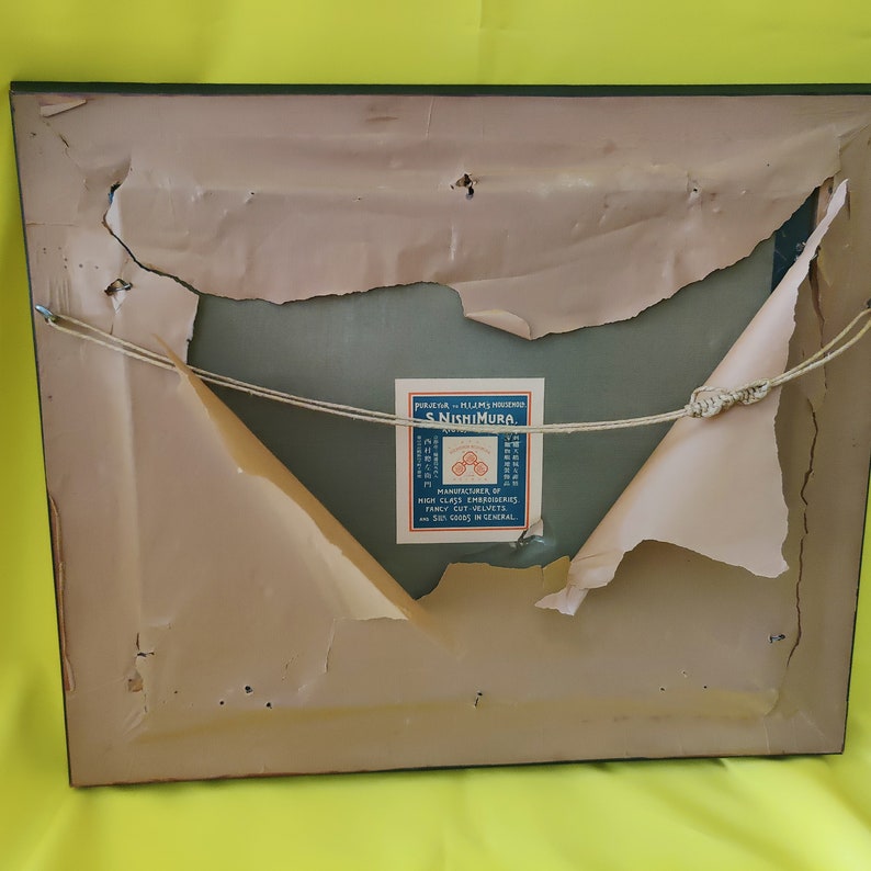 May include: The back of a framed picture with a label that reads "FOR JAPAN - HIJMS INSPECTED S. NISHIMURA - MANUFACTURERS OF HIGH CLASS EMBROIDERIES, FAMILY CUT SILKS, AND SILK GOODS IN GENERAL."