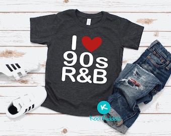 May include: A dark gray t-shirt with a white graphic that says "I love 90s R&B" with a red heart in place of the word "love".