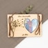 May include: A wooden box with a heart-shaped cutout, revealing money inside. The box is decorated with a dandelion and the text "Kleiner Wanscherfaller f&uuml;r Malea".