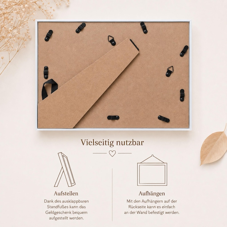 May include: A rectangular white picture frame shown from the back, featuring a brown backing board, a hinged support stand, and multiple black metal swivel clips. Below, text and line drawings illustrate two ways to display the frame: standing up or hanging on a wall.
