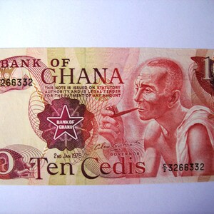 May include: A red and white 10 Cedi banknote from Ghana, featuring a portrait of a man with a pipe, the text "BANK OF GHANA", and the date "2nd Jan 1978".