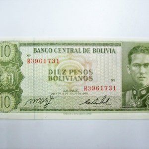 Może przedstawiać: Boliwijskie banknoty w kolorze zielonym i białym z nadrukowaną liczbą 10. Banknot przedstawia portret mężczyzny w mundurze wojskowym oraz tekst "Banco Central de Bolivia" i "Diez Pesos Bolivianos".