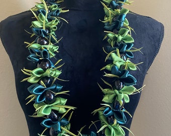 Orchid with kukui leaf lei