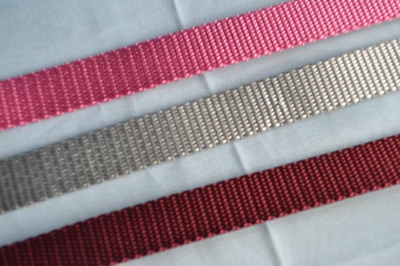 3/4 Inch of Mauve Pink, Silver Gray, Maroon 100% nylon webbing standard weight.