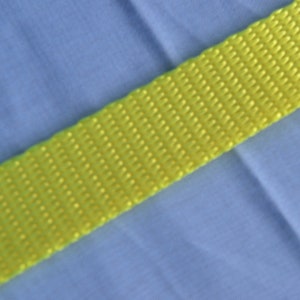 May include: A bright yellow webbing strap with a textured surface.