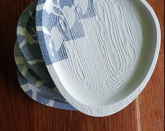 Set of 4 oval shaped white and blue textured plates