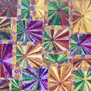 May include: A quilt made of colorful fabric squares with a sunburst pattern in each square. The fabric is a mix of green, purple, brown, and yellow.