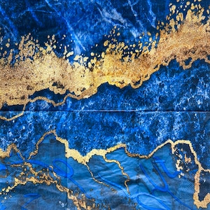 May include: Abstract art print with a blue and gold color scheme. The print features a swirling pattern of gold paint on a blue background.