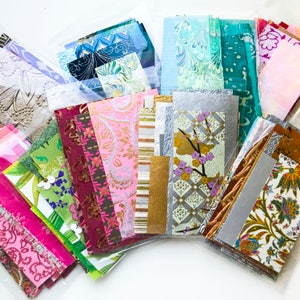 May include: Assortment of colorful patterned paper sheets in various sizes and textures. The papers feature floral, geometric, and abstract designs.