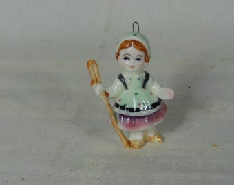 Vintage. Walt Disney-Productions--Mini Boy sitting In A Tulip--Its A Small World Ornament--Cerramic