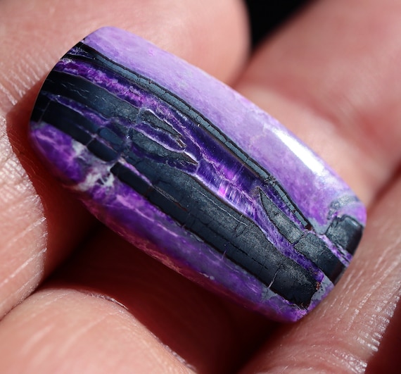 Fibrous Sugilite cabochon with some fine chatoyant areas. Wessels Mine, Northern Cape South Africa. 23 carats