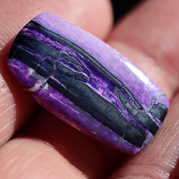 Fibrous Sugilite cabochon with some fine chatoyant areas. Wessels Mine, Northern Cape South Africa. 23 carats