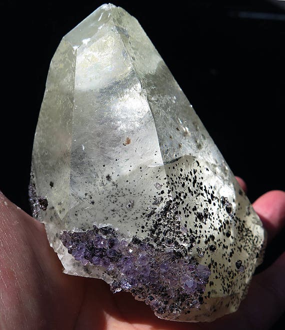 A large, 1 pound 10 oz. Calcite crystal with amethyst and rainbows