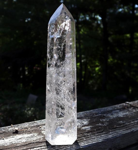 Excellent Crystal Rock Quartz polished Point. No milky inclusions, reflective internal veils. 10.5 inch tall. Tip perfect.  Stands perfectly