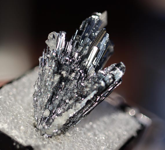 Fine stibnite with calcite thumbnail. Herja, Romania. Old Joel Vicary Collection label