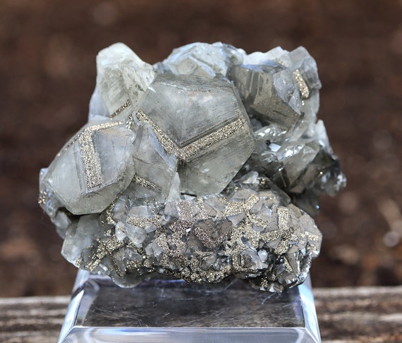 Benz growth Pyrite on shallow scalenohedron calcite crystals. Daye County, Hubei Province, China. Presents perfectly.