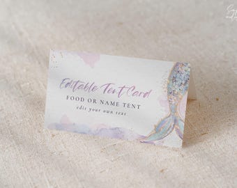 May include: Editable tent card with a mermaid tail design. The card is white with a watercolor background in shades of pink and purple. The text on the card reads "Editable Tent Card, Food or Name Tent, edit your own text".