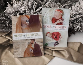 May include: Two Christmas cards with family photos. One card reads "Merry Little Christmas" with a family photo and text. The other card reads "More and Merrier" with a baby photo and text. The cards are on a neutral background.
