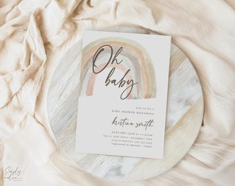 May include: A baby shower invitation with a watercolor rainbow design in muted tones. The text "Oh baby" is written in elegant script above the rainbow. Additional text includes the honoree's name, date, time, and location.
