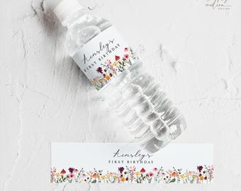 May include: Water bottle label with a floral design and the text "Kinsley's First Birthday".