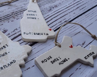 Personalized  "Home Sweet Home" hanging ornament on natural twine in your choice of state and location combination.